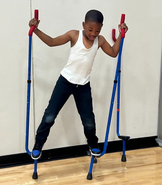 A child playing on a climbing structure.