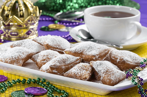 Powdered sugar beignets served with coffee