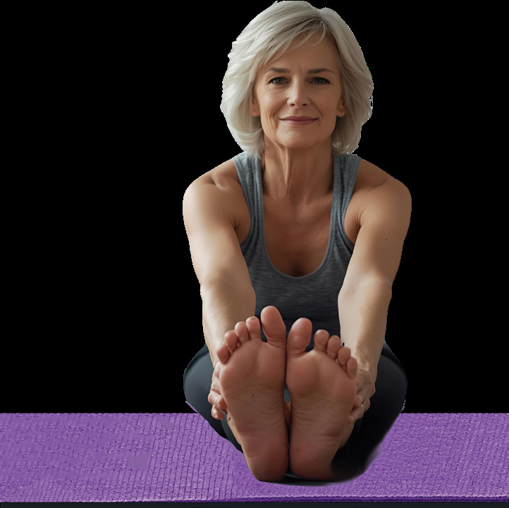 A woman sitting cross-legged in a yoga pose, smiling