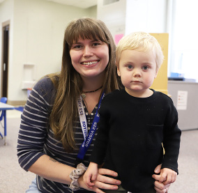 A teacher and a young child interacting