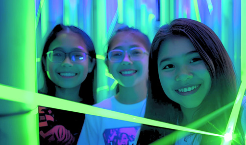 Students with neon lights at Fun Lab