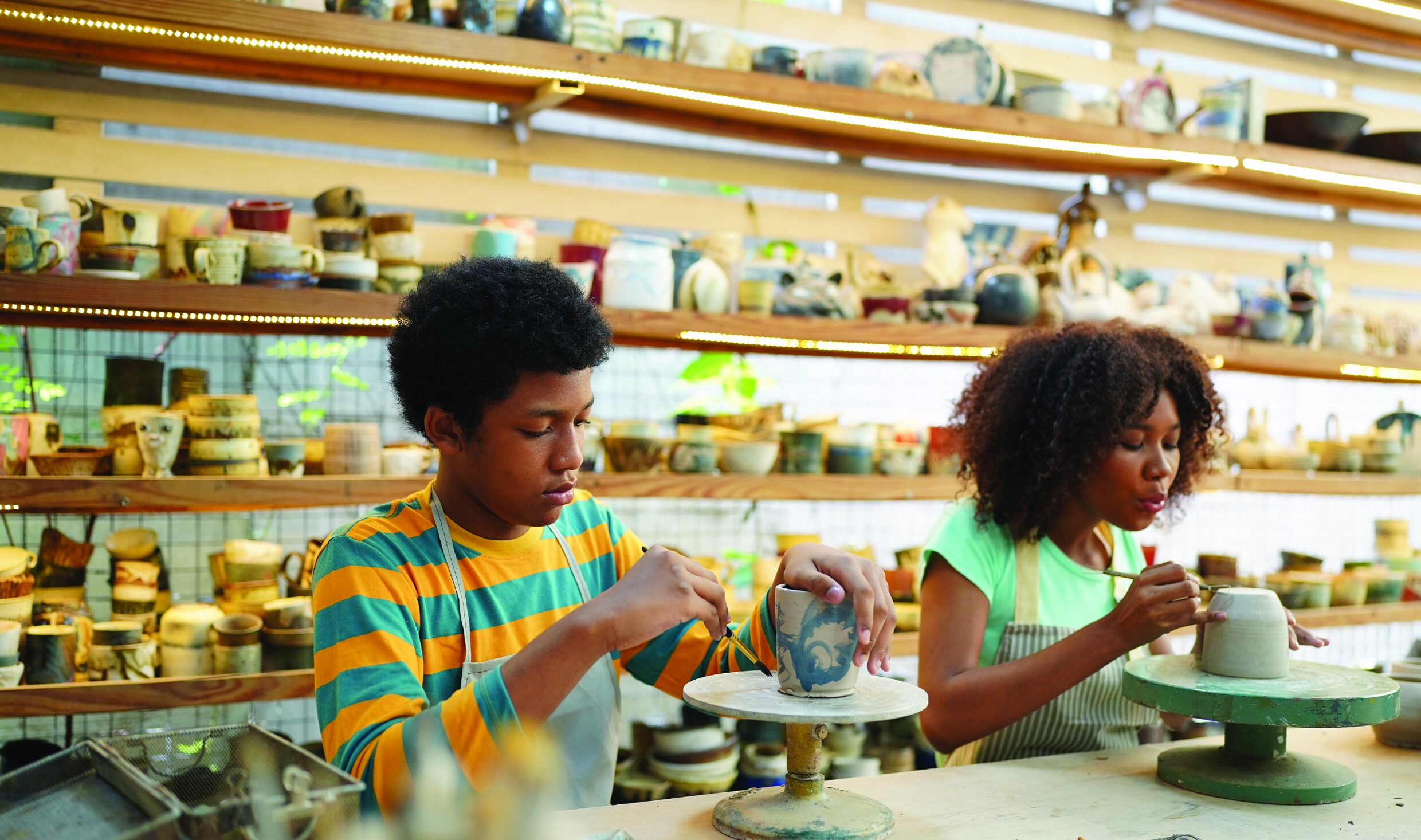 Children working on pottery projects in a classroom