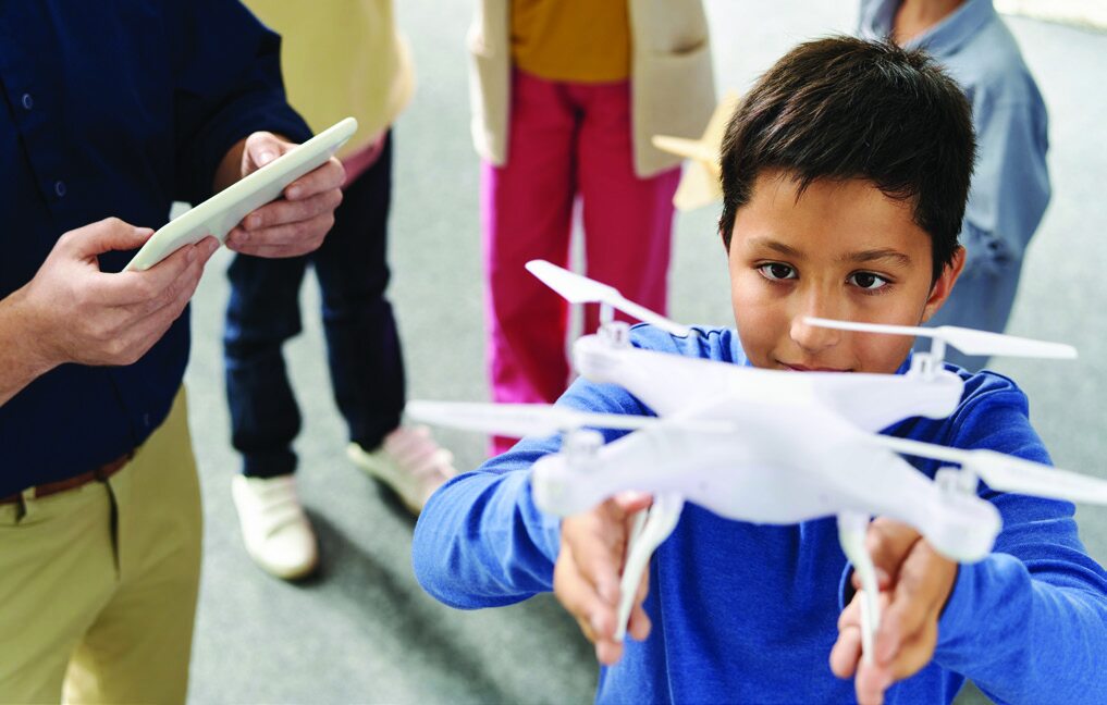 Student preparing a drone for flight