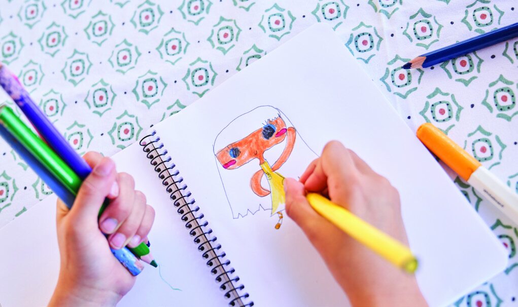 Artistic drawing on a notepad with markers