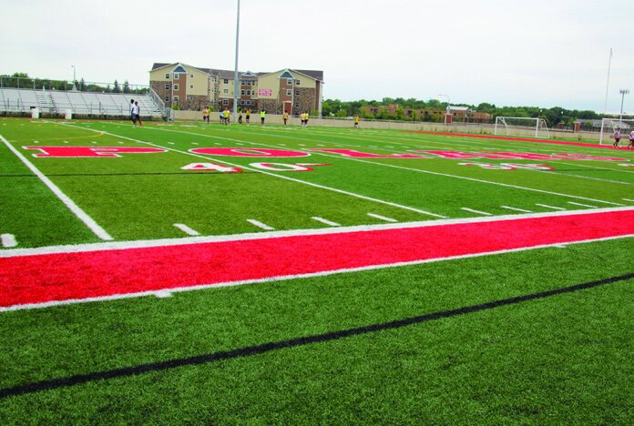 A large outdoor artificial turf athletic field.