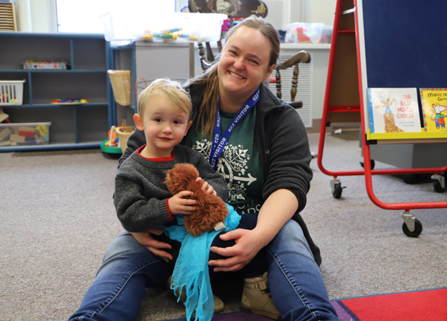 Teacher and child playing in a classroom