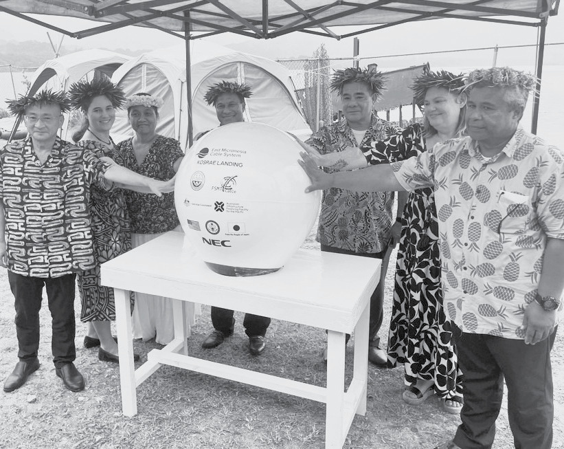 U.S. Embassy and local leaders at the landing ceremony for the east Micronesia Cable System in Kosrae, people gathered around a ceremonial marker under a tent