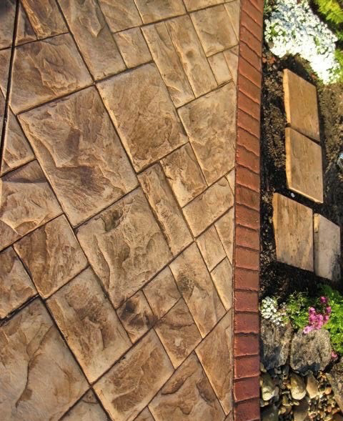 Decorative stamped concrete walkway in a garden setting