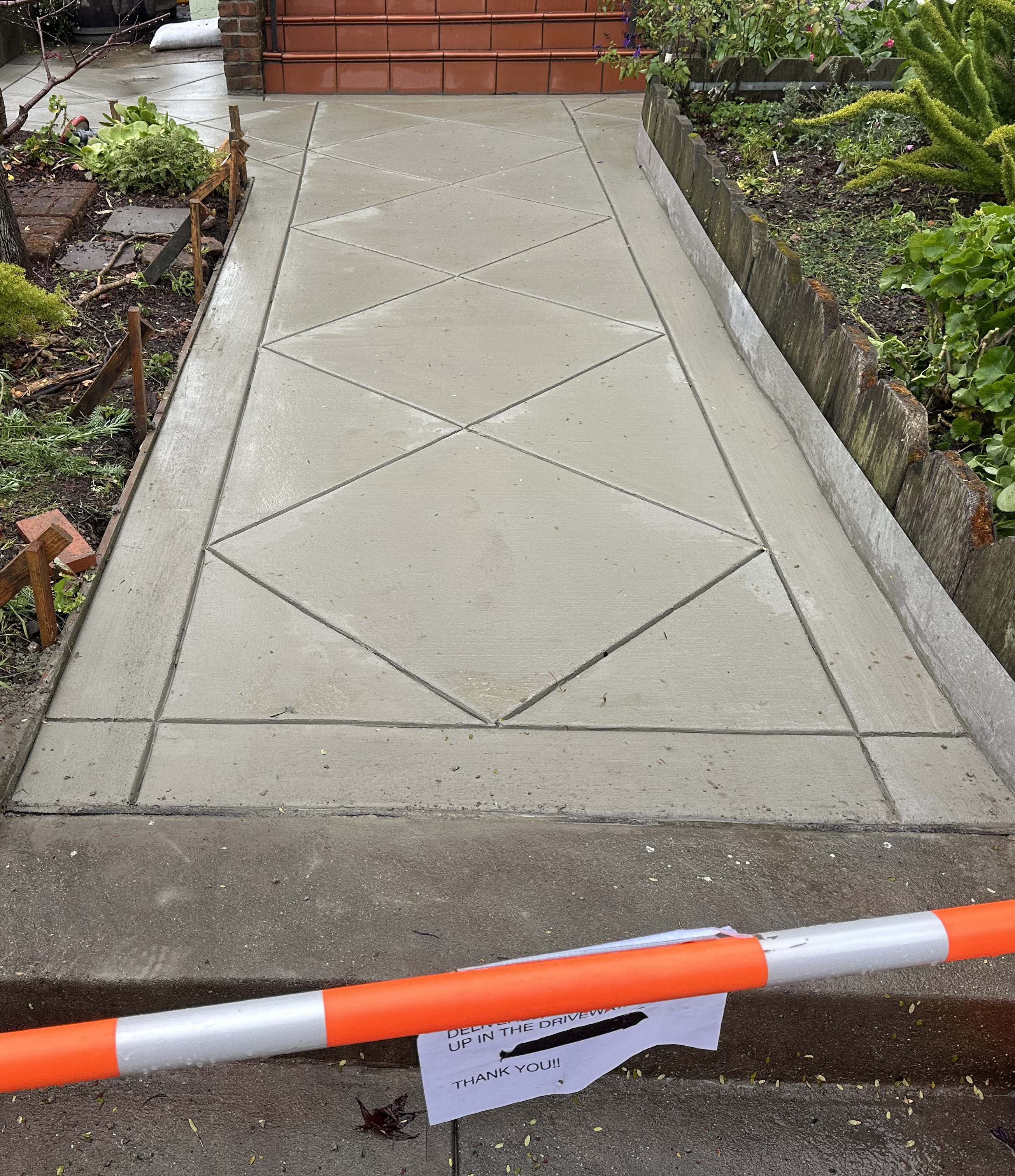 Residential concrete walkway with intricate diamond pattern