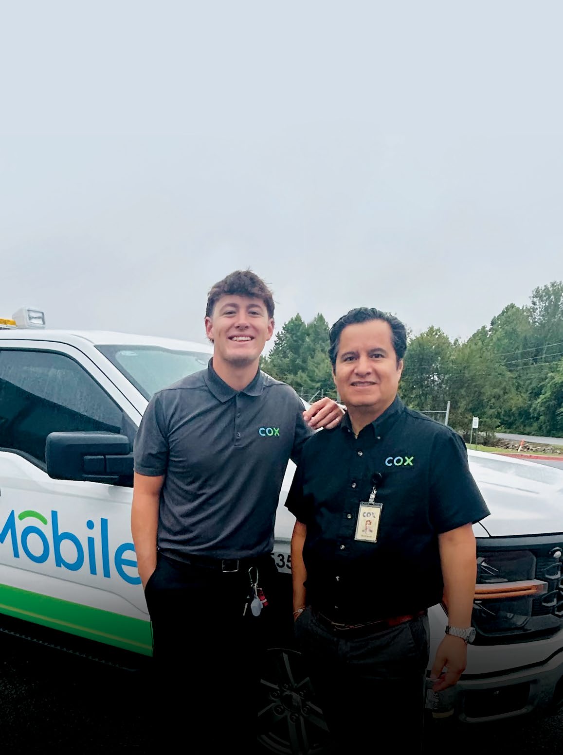 Pepe Rodriguez and colleague standing outside next to Cox Mobile truck