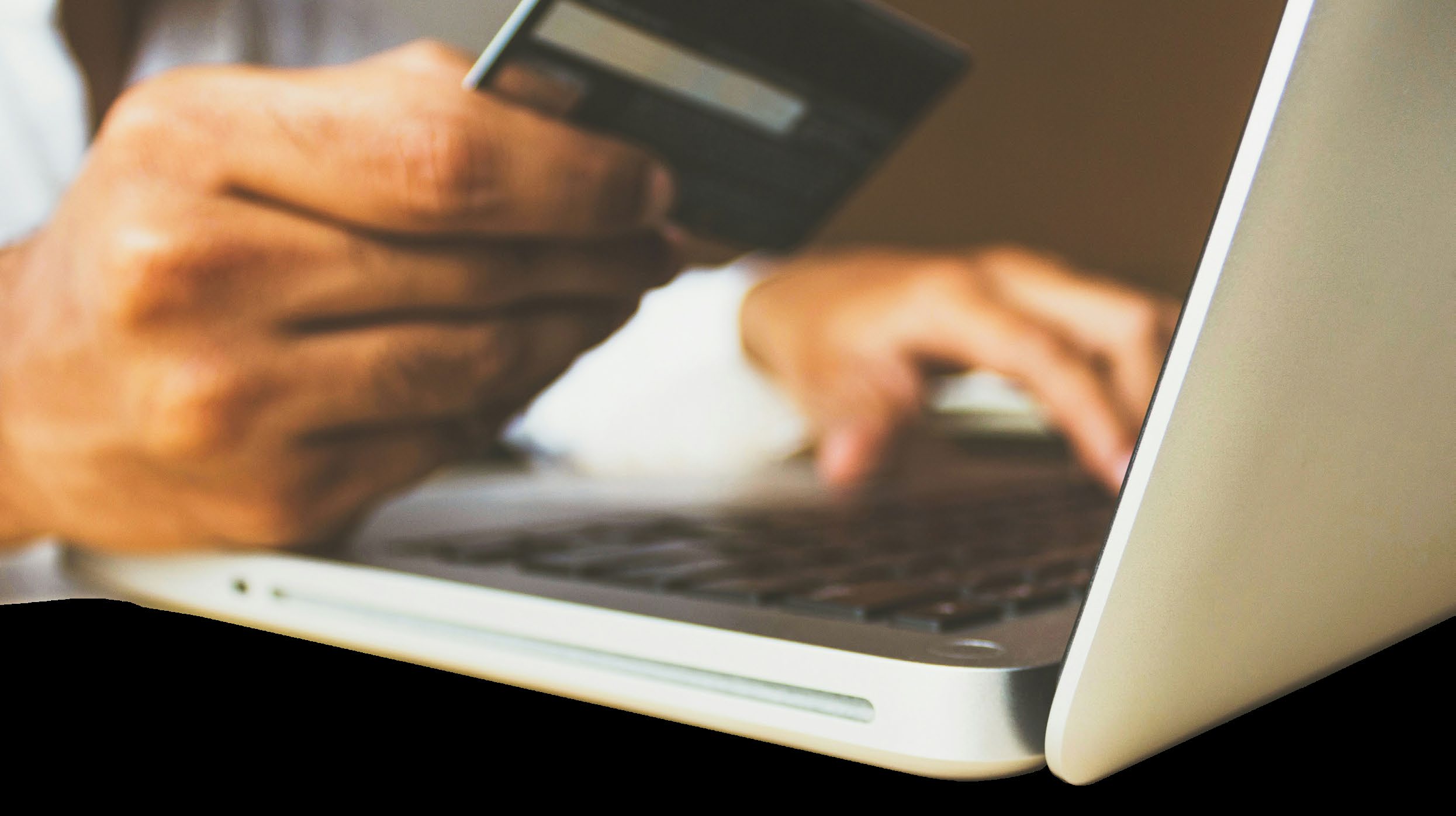 Person using laptop and credit card