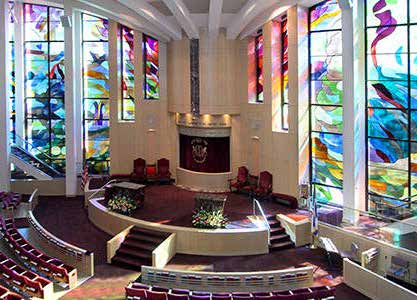 The Morris and Sylvia Selenium Sanctuary at Temple Israel showing beautiful stained glass windows and the bimah