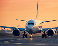 An airplane on the runway at Tweed-New Haven Airport during sunset.