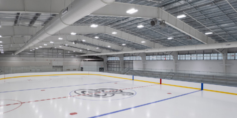 Interior view of the Belmont Skating Rink, showing the ice sheet and spectator bleachers