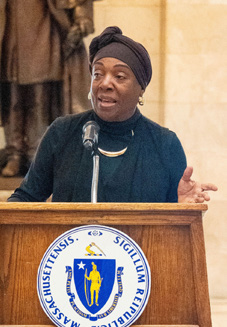 Andrea Gayle-Bennett speaking at a podium