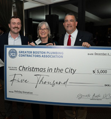 Andrew DeAngelo, Maureen Rogers, and Kenneth Reagan with a check for Christmas in the City