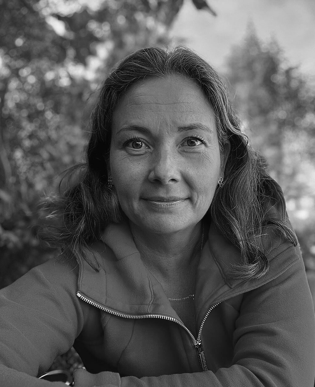 Portrait of Heini Lahtela, HR Business Partner at Infineon Technologies, smiling in an outdoor setting.
