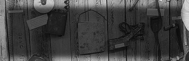 Close-up detail of a wall with assorted vintage tools and implements hanging at the museum.