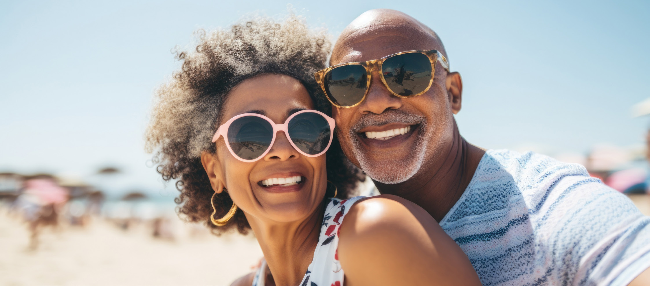 Smiling middle-aged couple at the beach