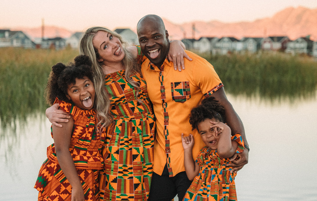 Frimpong and his family in colorful kente-pattern outfits