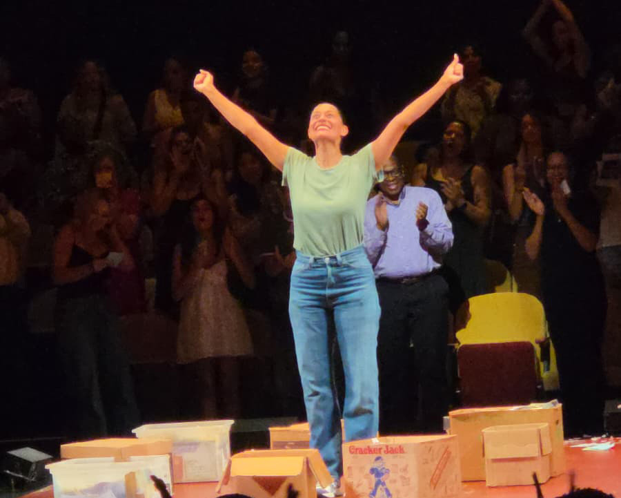 Tracee Ellis Ross onstage at the Hudson Theatre, arms raised as the audience applauds