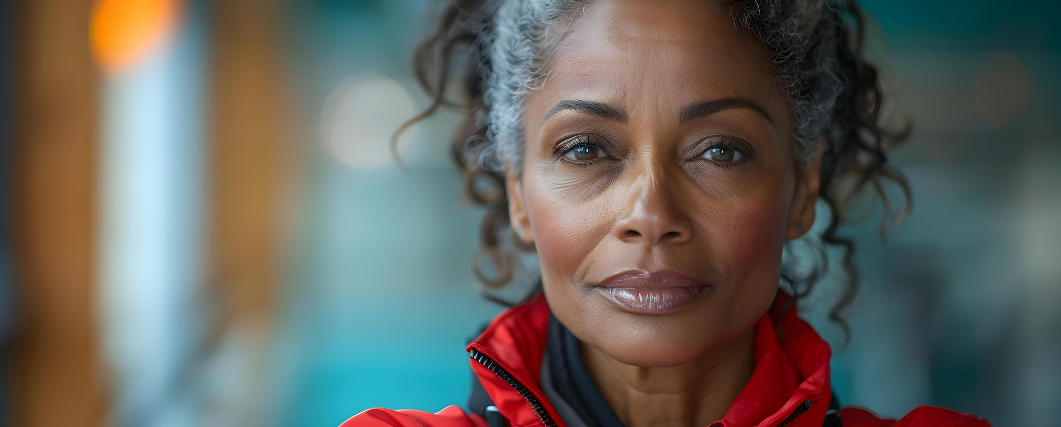 Close-up portrait of a woman with curly grey hair